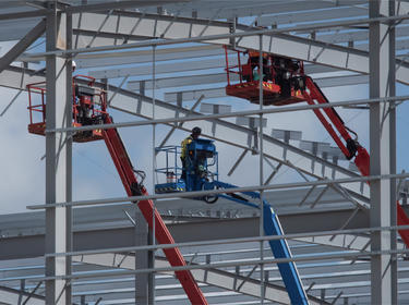 Workers on cranes in a construction site