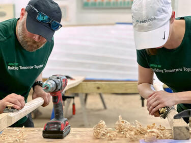 Twee Prologis-medewerkers die hout schuren tijdens een IMPACT Day-project